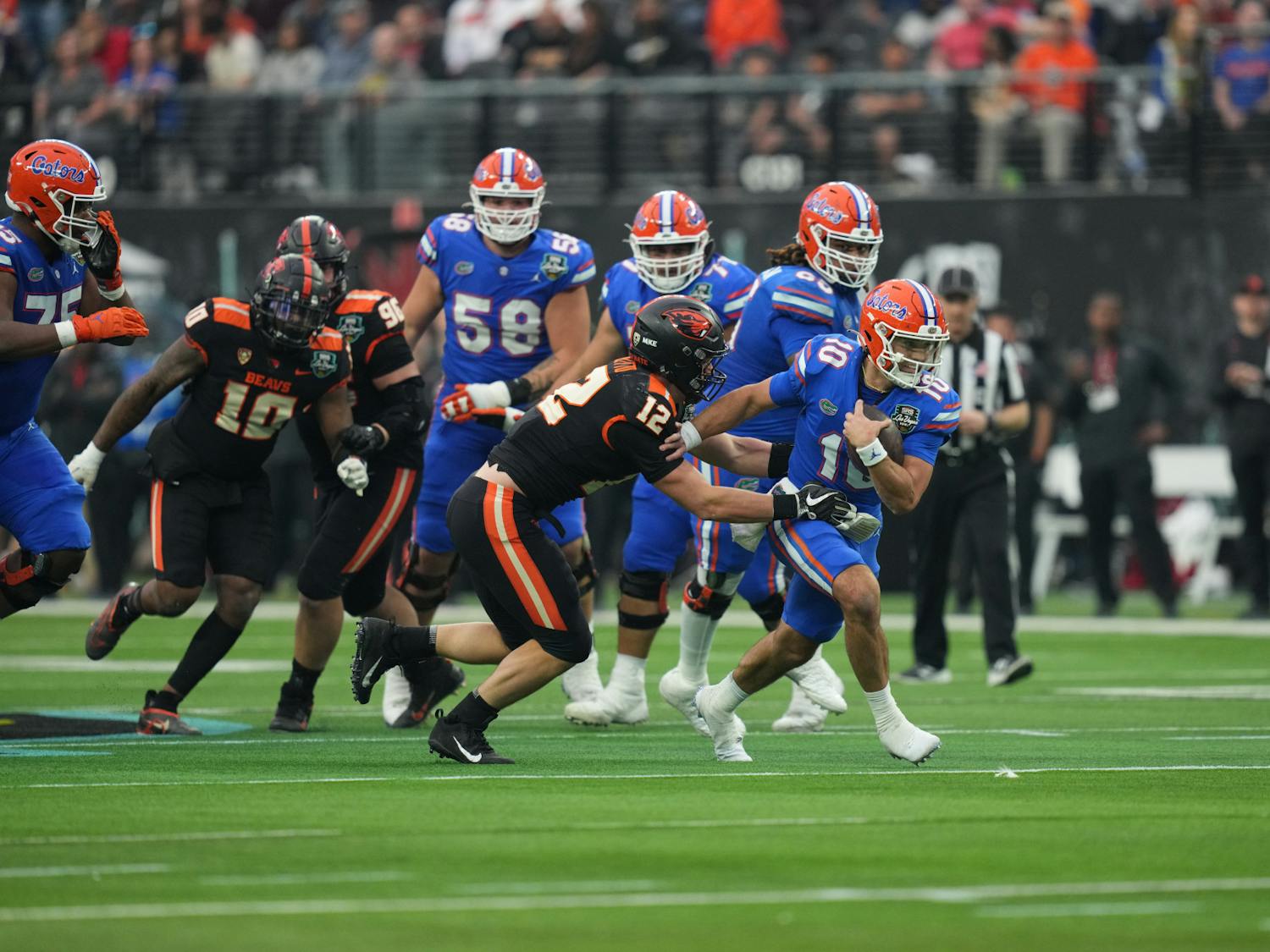 Florida quarterback Jack Miller III fights to ward off a tackle by an Oregon State defender in the Gators&#x27; loss Saturday, Dec. 17, 2022.(Photo by Al Powers / ESPN Images)