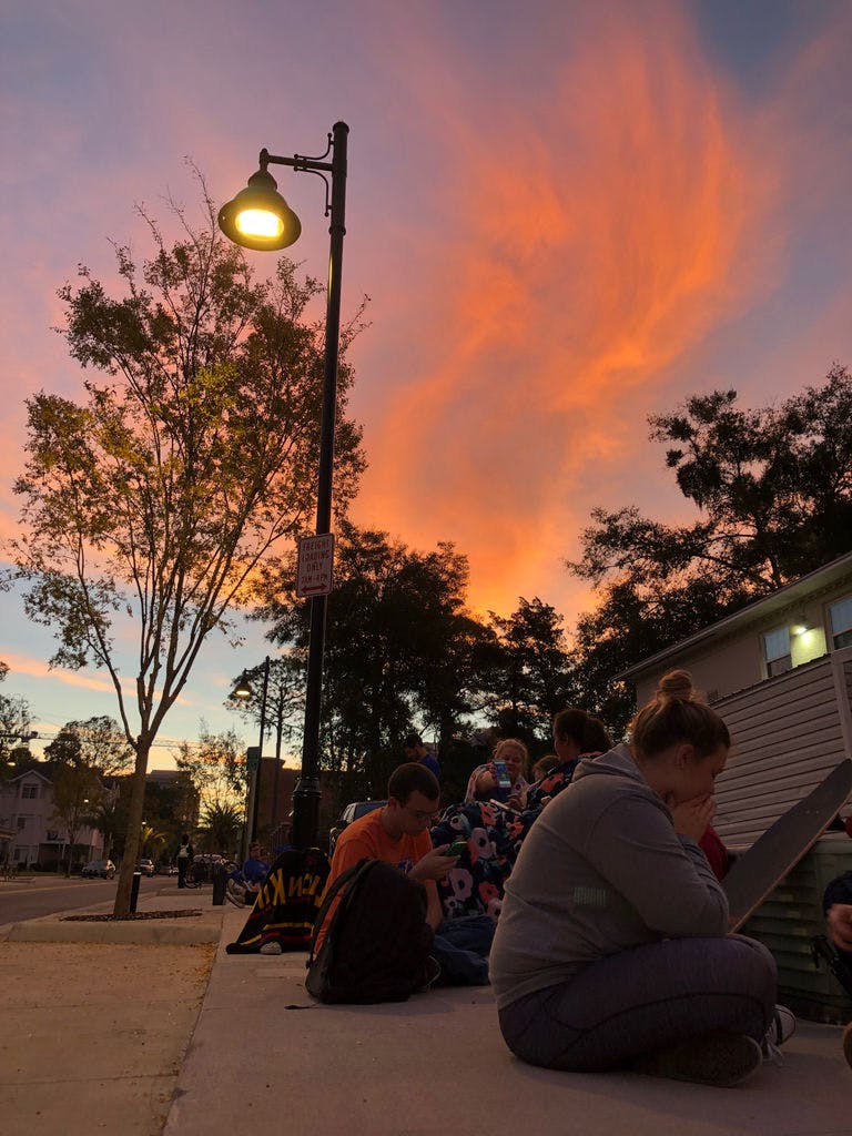 UF Alumni Association student members wait in line behind Emerson Alumni Hall to pick up their “Beat Missouri” long-sleeve shirt Thursday morning.