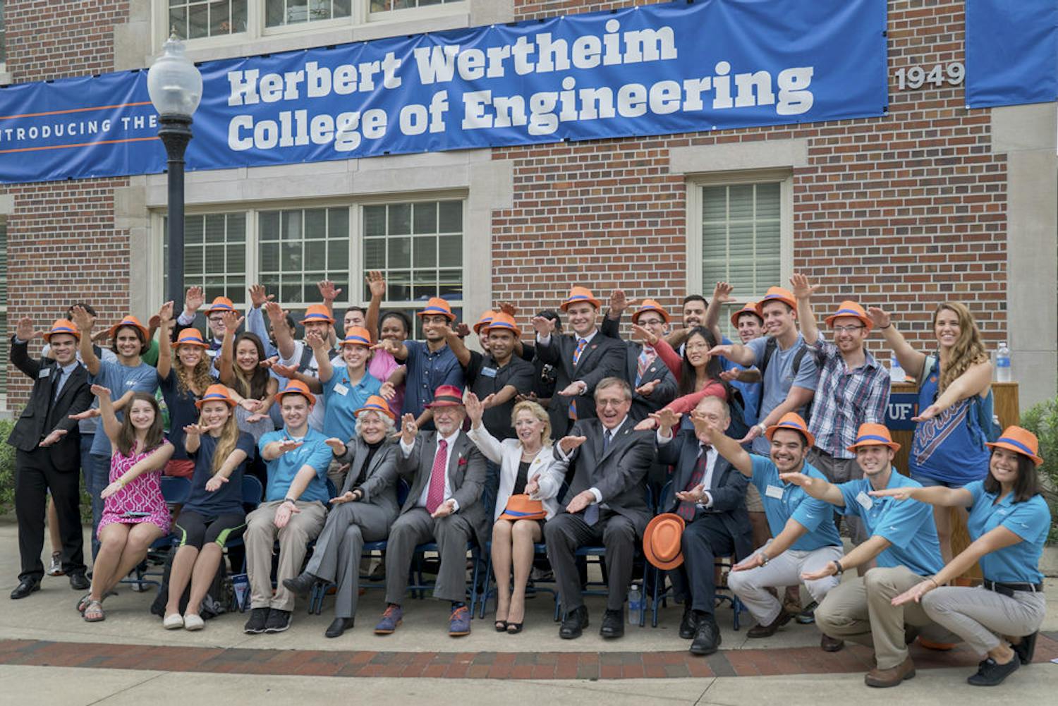 Herbert Wertheim (front row, fifth from left) does the Gator Chomp with UF students and faculty outside Weil Hall on Oct. 1, 2015. The College of Engineering is using Wertheim’s $50 million donation to launch a $300 million research initiative.