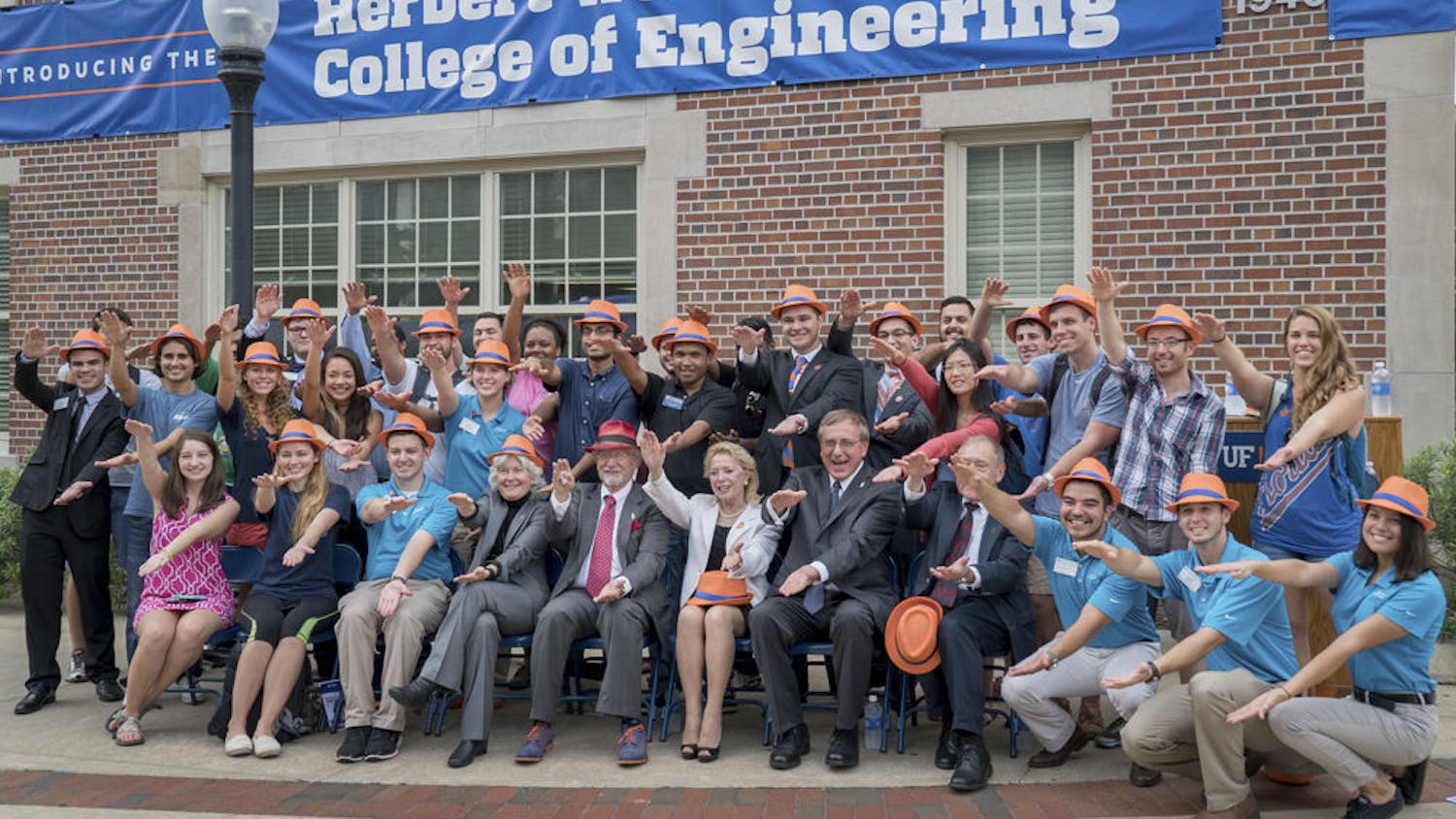 Herbert Wertheim (front row, fifth from left) does the Gator Chomp with UF students and faculty outside Weil Hall on Oct. 1, 2015. The College of Engineering is using Wertheim’s $50 million donation to launch a $300 million research initiative.