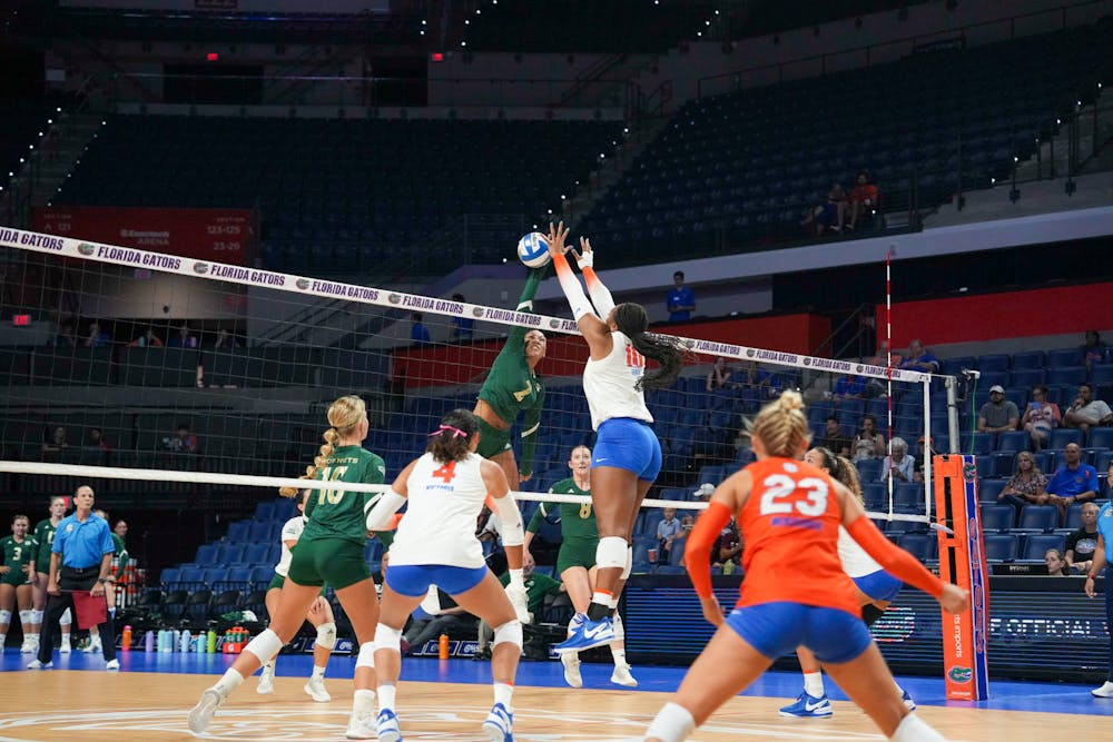 Junior middle back Gabrielle Essix blocks the ball in the Gators' 3-2 win against the Sacramento State Hornets Thursday, Sept. 8, 2023. 