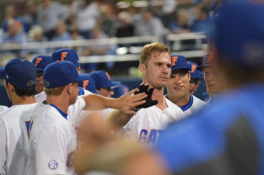 Peter Alonso celebrates with teammates after hitting a home run during Florida's win against Texas A&amp;M on April 1, 2016, at McKethan Stadium.