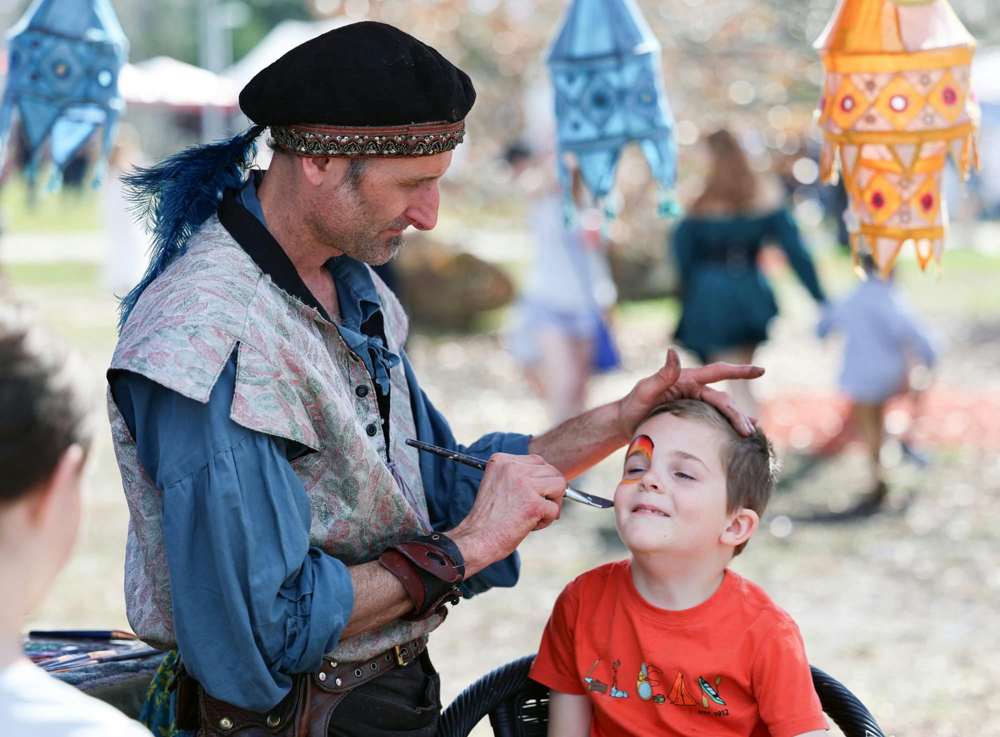 A young boy gets his face painted at the Hoggetowne Medieval Faire at Depot Park in Gainesville, Fla., Saturday, Jan. 27, 2024.