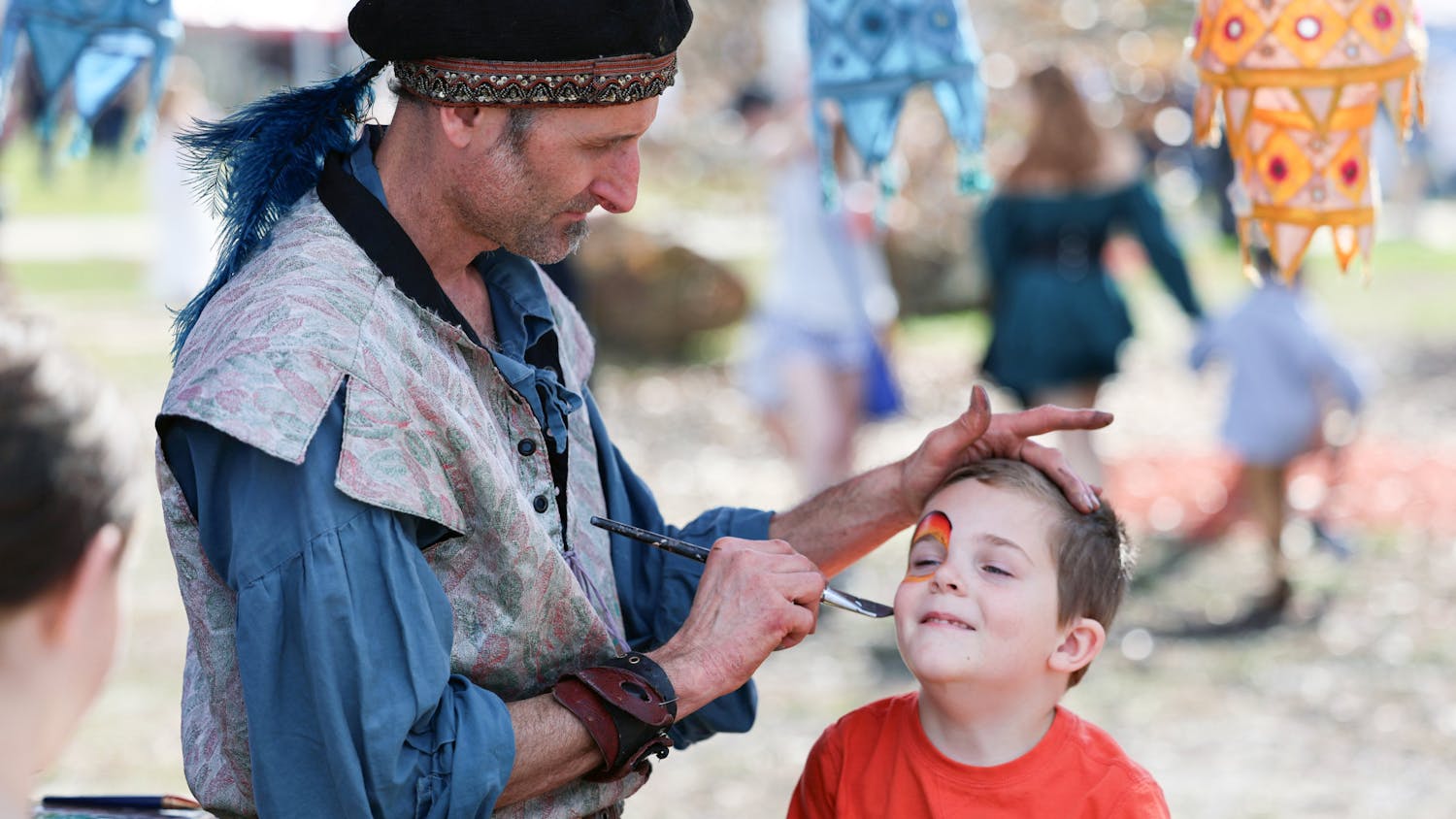 A young boy gets his face painted at the Hoggetowne Medieval Faire at Depot Park in Gainesville, Fla., Saturday, Jan. 27, 2024.