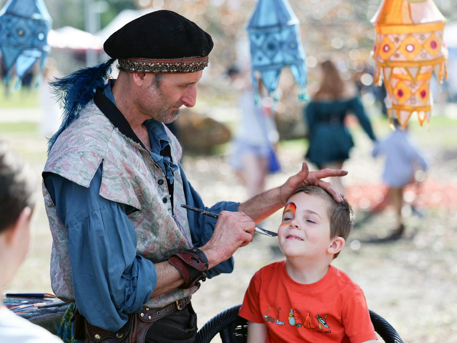 A young boy gets his face painted at the Hoggetowne Medieval Faire at Depot Park in Gainesville, Fla., Saturday, Jan. 27, 2024.