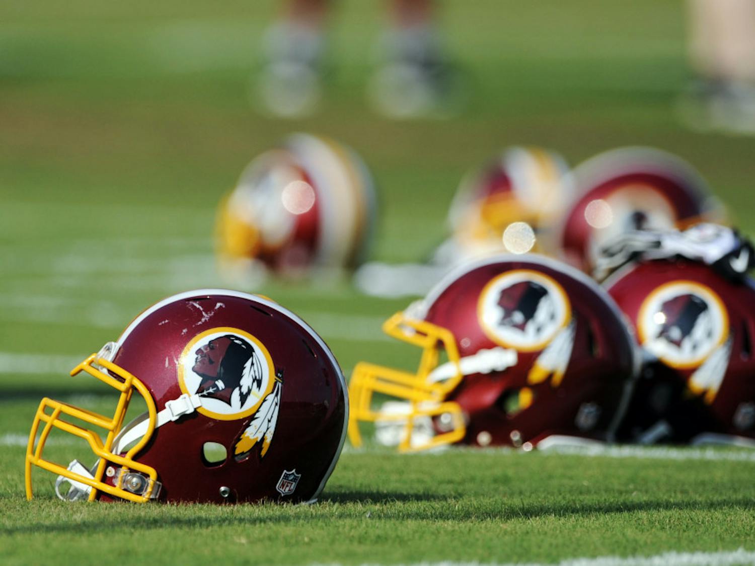 Washington Redskins helmets sit on the field during NFL football minicamp. The U.S. Patent Office ruled Wednesday that the Washington Redskins nickname is “disparaging of Native Americans.”