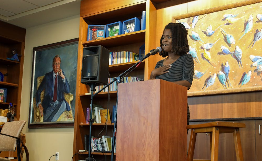 Poet LaChelle Hope reads her poem to a crowd at 'I Am…Warrior': Pop-up Poetry and Art Gallery event on Thursday, April 9, 2026, in Gainesville, Fla.