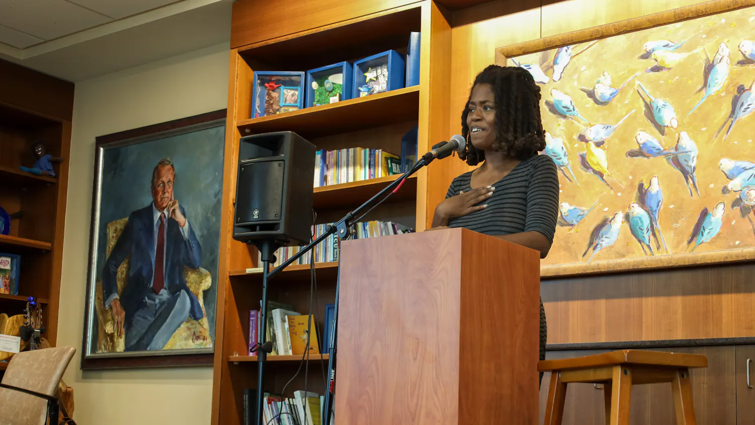 Poet LaChelle Hope reads her poem to a crowd at 'I Am…Warrior': Pop-up Poetry and Art Gallery event on Thursday, April 9, 2026, in Gainesville, Fla.