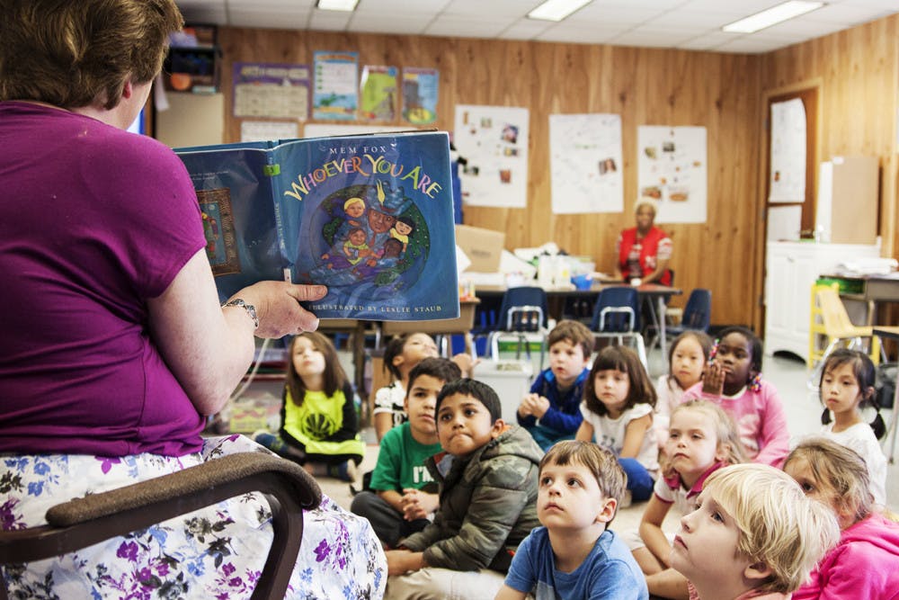 Karen Melvin, a kindergarten teacher at Littlewood Elementary School, reads “Whoever You Are” by Mem Fox to her kindergarten class. 
