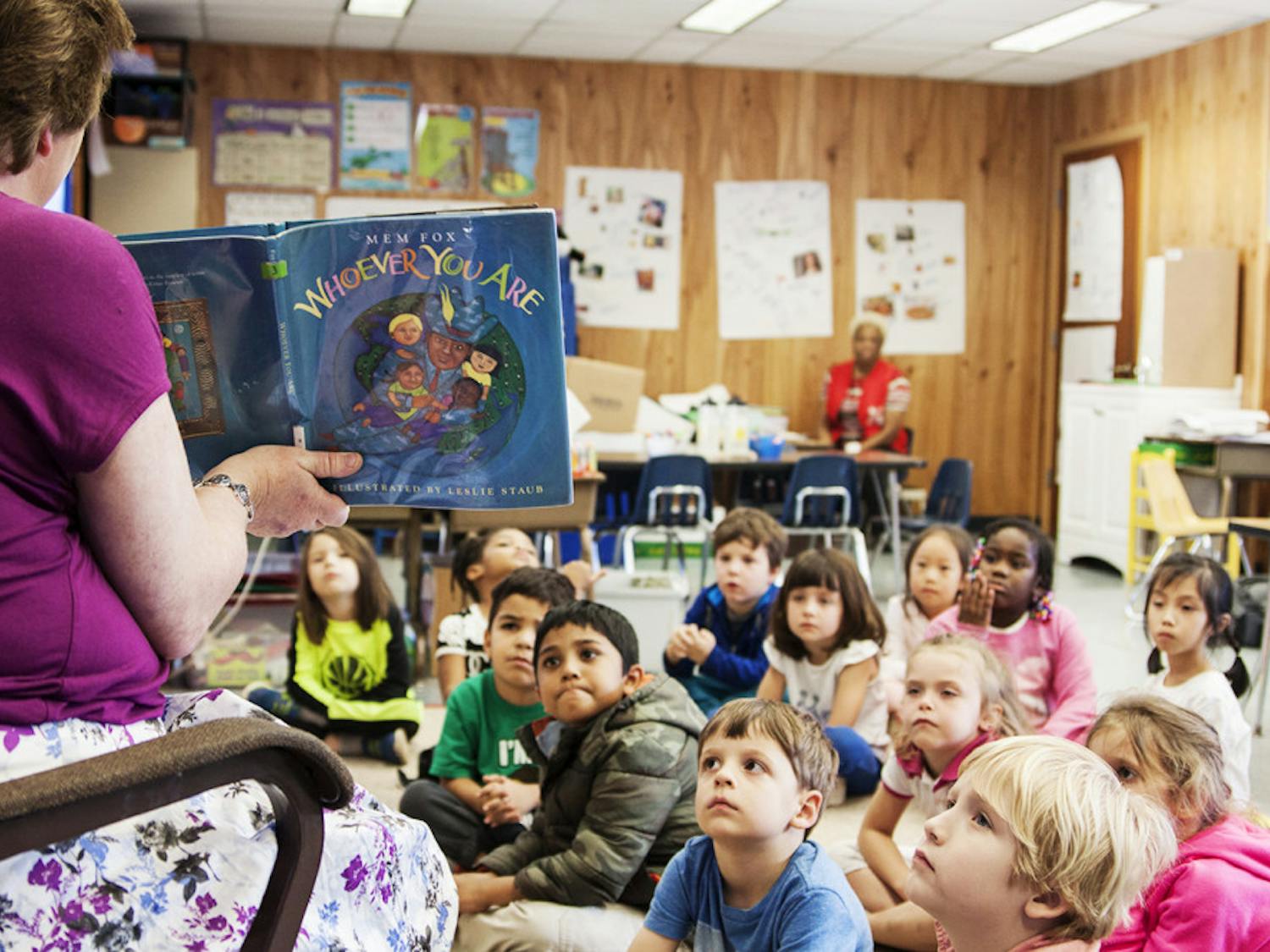  Karen Melvin, a kindergarten teacher at Littlewood Elementary School, reads “Whoever You Are” by Mem Fox to her kindergarten class. 