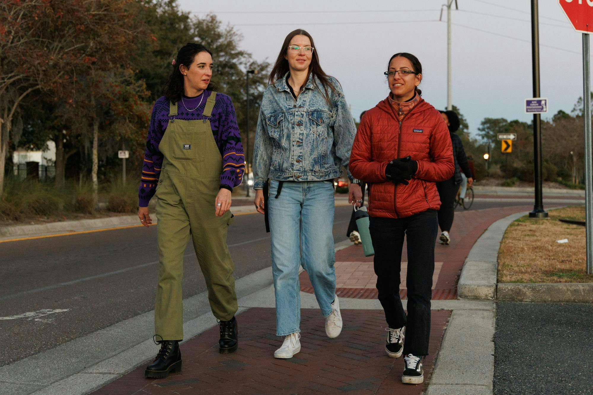 Hollyn Belhart, Christy Lynch and Natalia Medina walk on trail during a City Girls Who Walk Gainesville meet in Gainesville, Fla., Wednesday, Jan. 28, 2026.