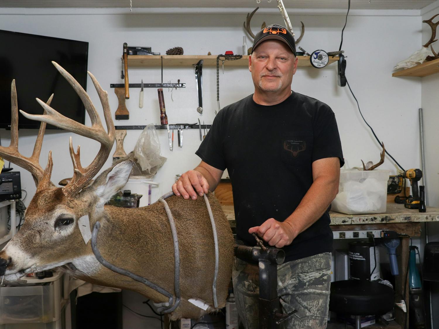 Jack Patton, 54, displays a taxidermy deer in his studio in Steinhatchee, Fla., on Saturday, Sept. 30, 2023.