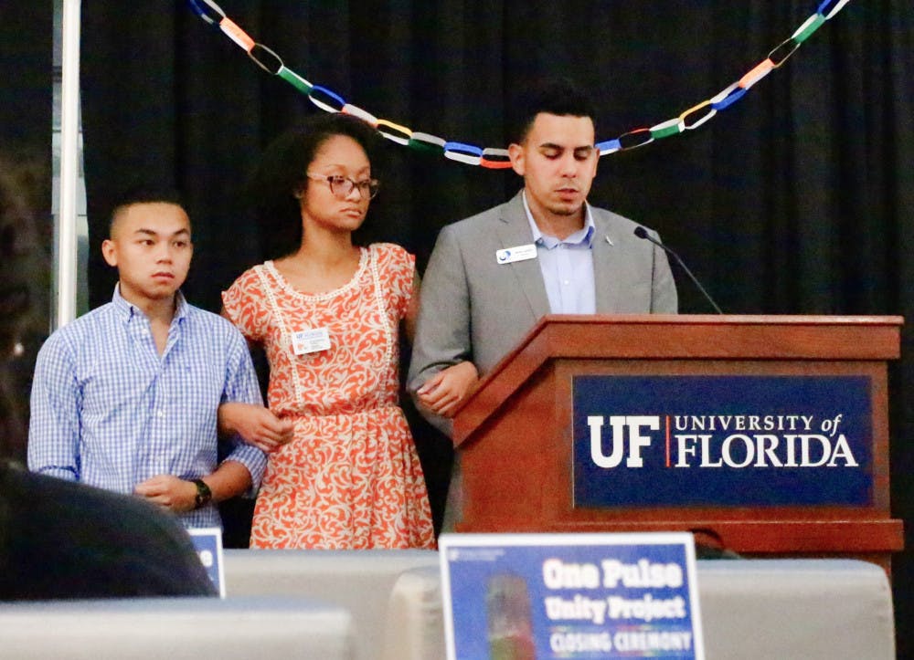 UF’s Multicultural &amp; Diversity Affairs executive director Lloren Foster speaks on Thursday morning at the closing ceremony for the One Pulse Unity Project, asking the crowd for a moment of silence to honor the victims of the Pulse shooting. Foster concluded everyone present was, "here to show solidarity not only for victims, families and communities… but for each other."