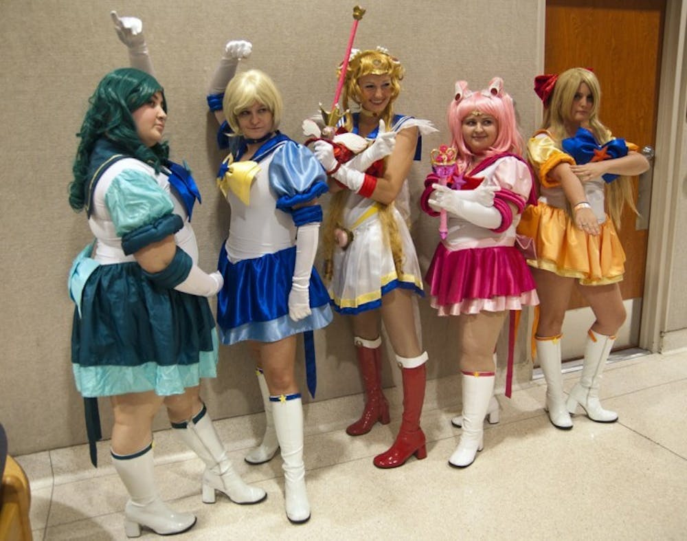 <p>SwampCon attendees dressed as Sailor Moon characters pose for a picture at the multi-genre convention held in the Reitz Union on Saturday.</p>