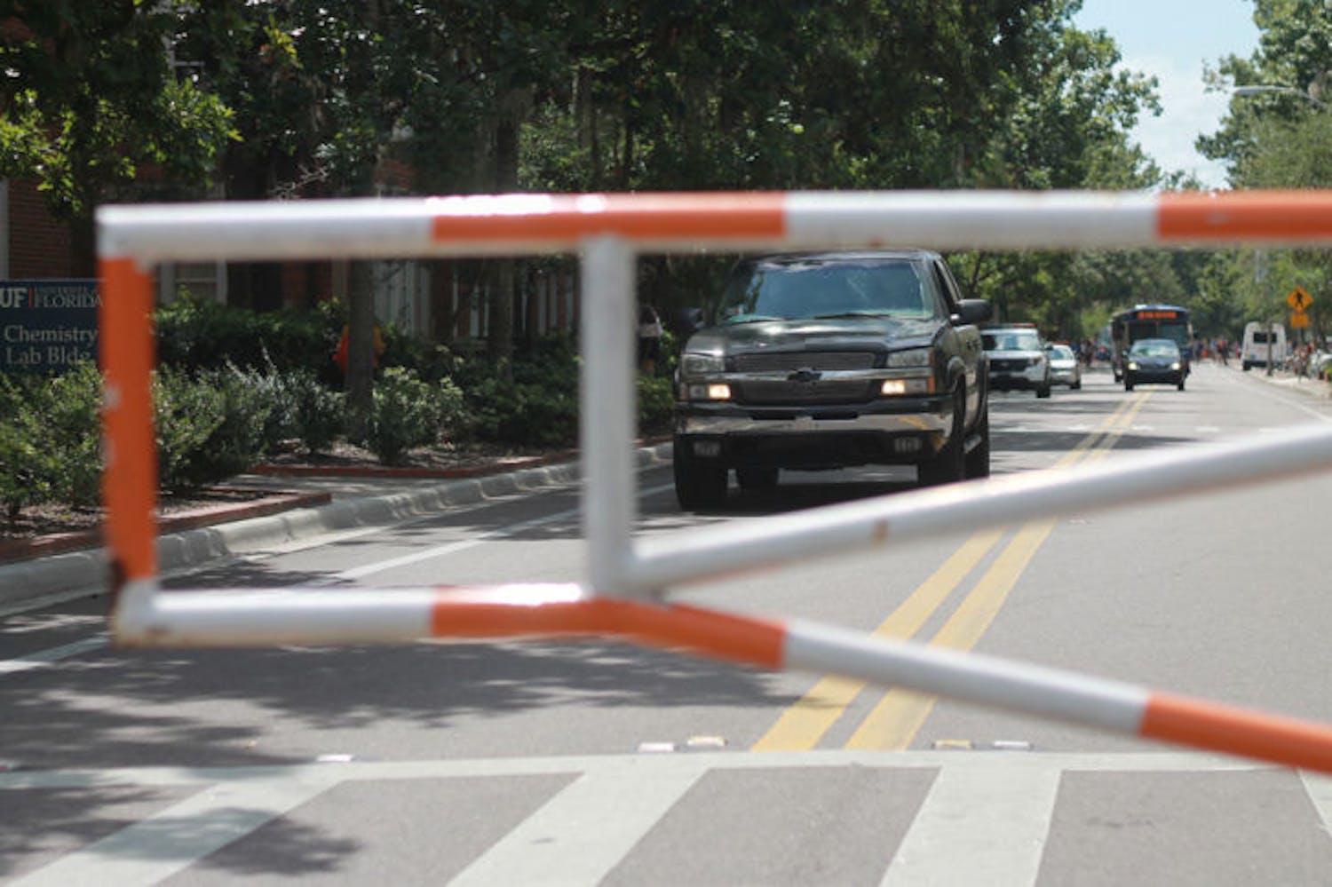 A driver attempts to drive around the barrier blocking Buckman Drive on Sept. 19. University Police frequently pulls over drivers crossing these barriers.