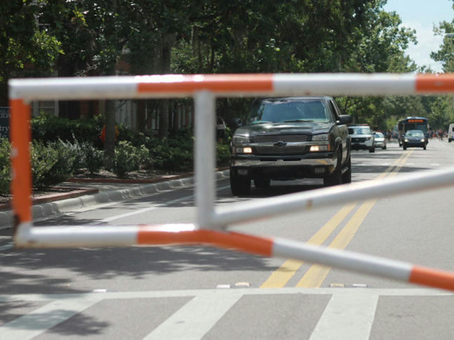 A driver attempts to drive around the barrier blocking Buckman Drive on Sept. 19. University Police frequently pulls over drivers crossing these barriers.