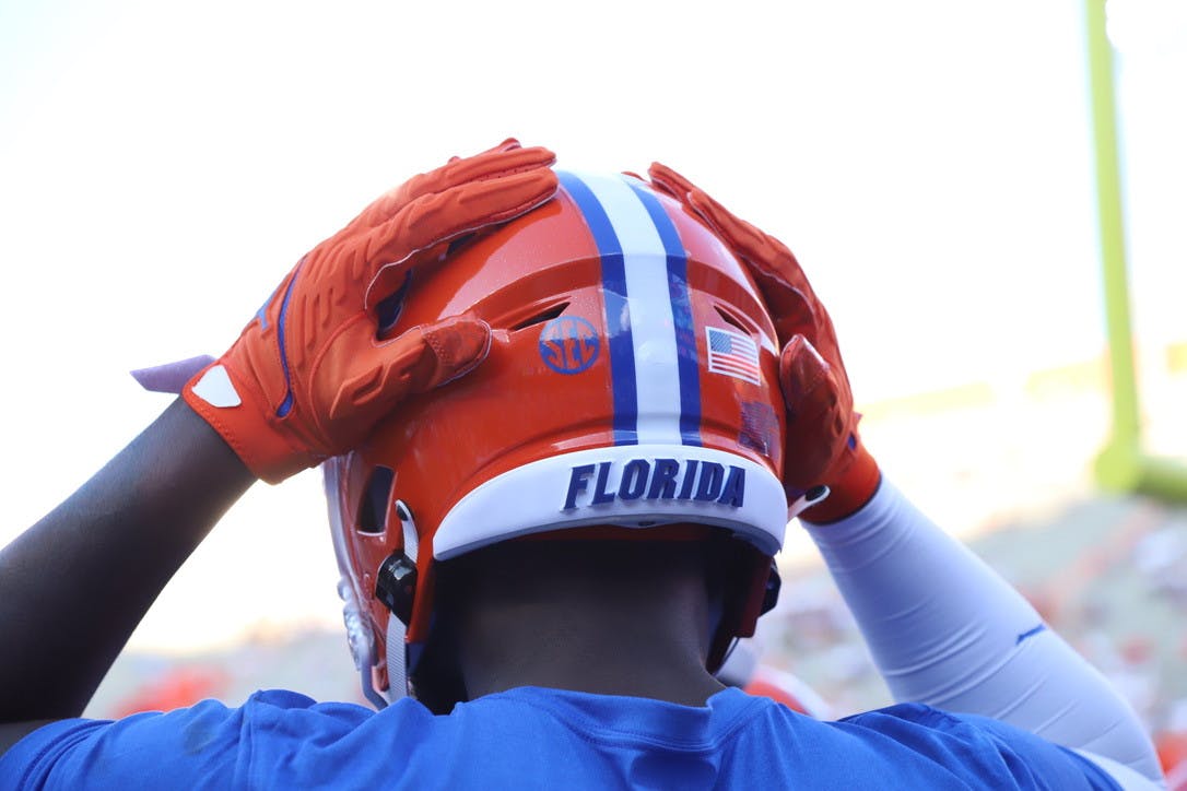 A Florida player touches his helmet during warmups before a game against Florida Atlantic on Sept. 4.
