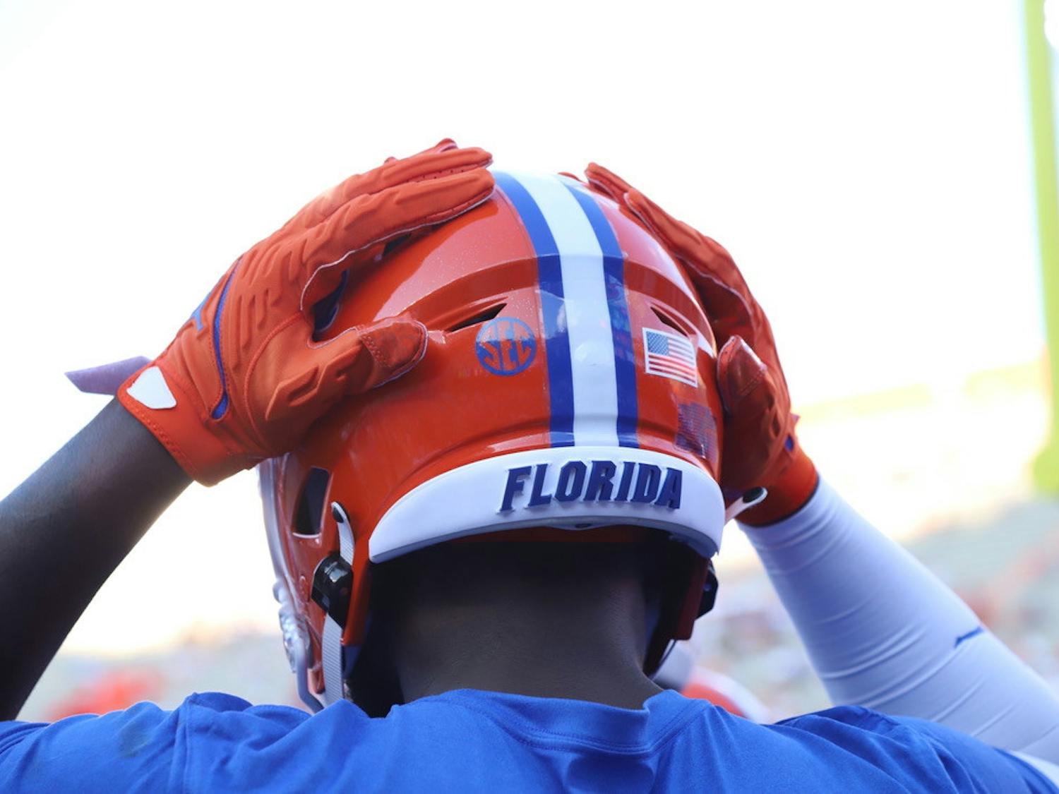 A Florida player touches his helmet during warmups before a game against Florida Atlantic on Sept. 4.