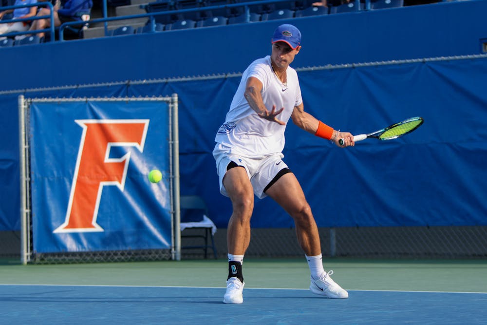 Florida graduate student Axel Nefve swings his racket in the Gators' 6-1 win over the Arkansas Razorbacks Friday, March 24, 2023.