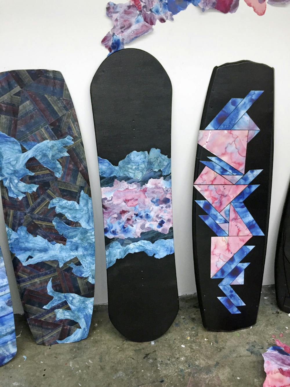 <p class="p1">Pictured are some of the art pieces designed by UF art senior Taylor Adams. Adams uses ink and water to design patterns that she arranges on wakeboards. She will have her first solo exhibition Friday at University Towne Center.</p>