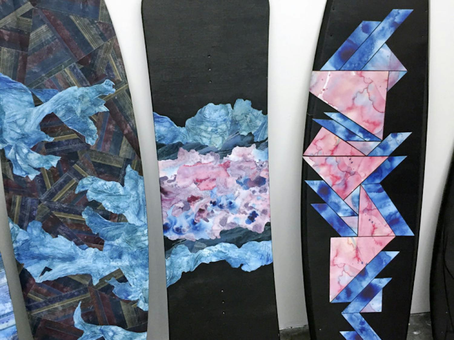 Pictured are some of the art pieces designed by UF art senior Taylor Adams. Adams uses ink and water to design patterns that she arranges on wakeboards. She will have her first solo exhibition Friday at University Towne Center.