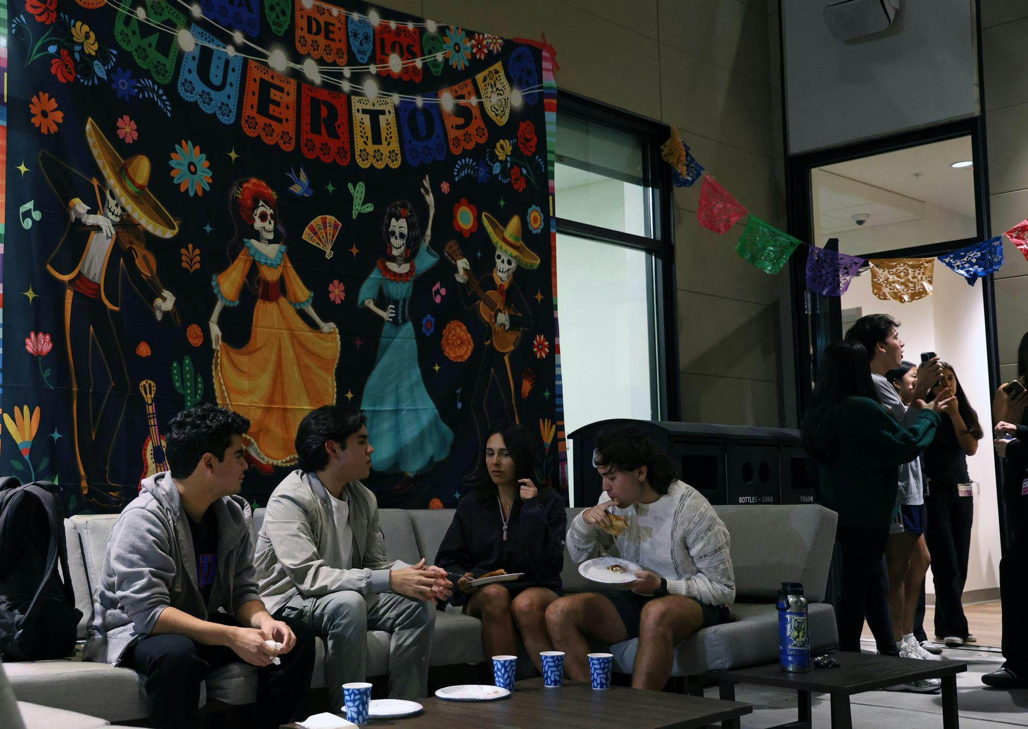 Attendees sit in the courtyard of the Institute of Hispanic-Latino Cultures during the Mexican American Student Association’s Día de los Muertos celebration on Monday, Nov. 3, 2025.