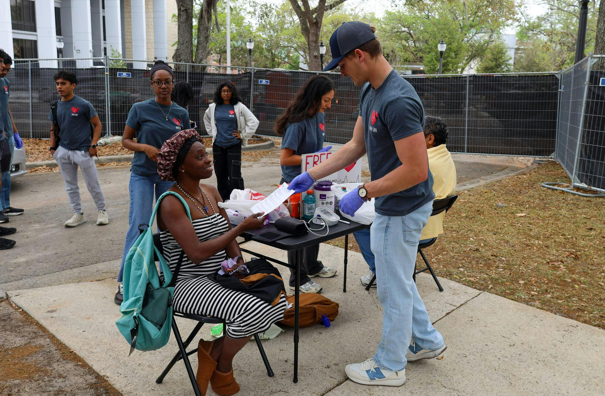 Lilliana Wells gets a blood pressure test from an H4H volunteer outside Gainesville City Hall, Sunday, March 29, 2026, in Gainesville, Fla.