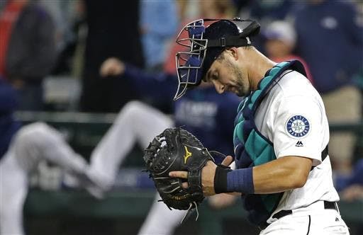 Seattle Mariners catcher Mike&nbsp;Zunino&nbsp;walks to the mound after the the Mariners defeated the Baltimore Orioles 12-6 in a baseball game Saturday, July 2, 2016, in Seattle.
