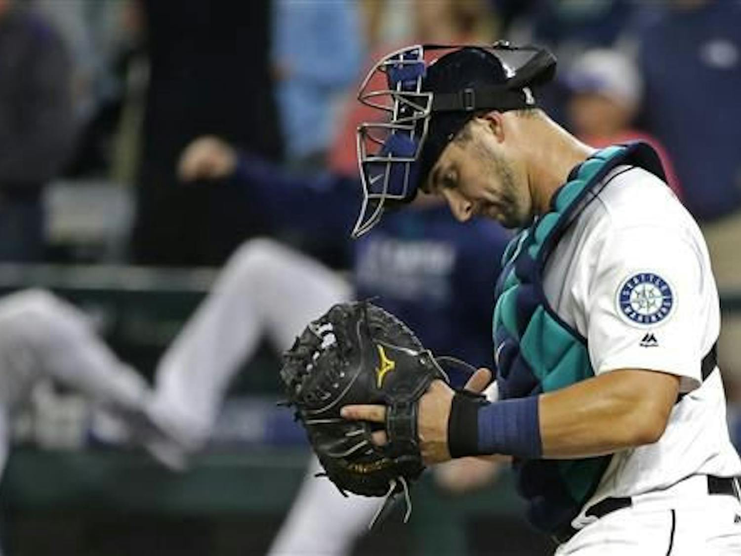 Seattle Mariners catcher Mike&nbsp;Zunino&nbsp;walks to the mound after the the Mariners defeated the Baltimore Orioles 12-6 in a baseball game Saturday, July 2, 2016, in Seattle.