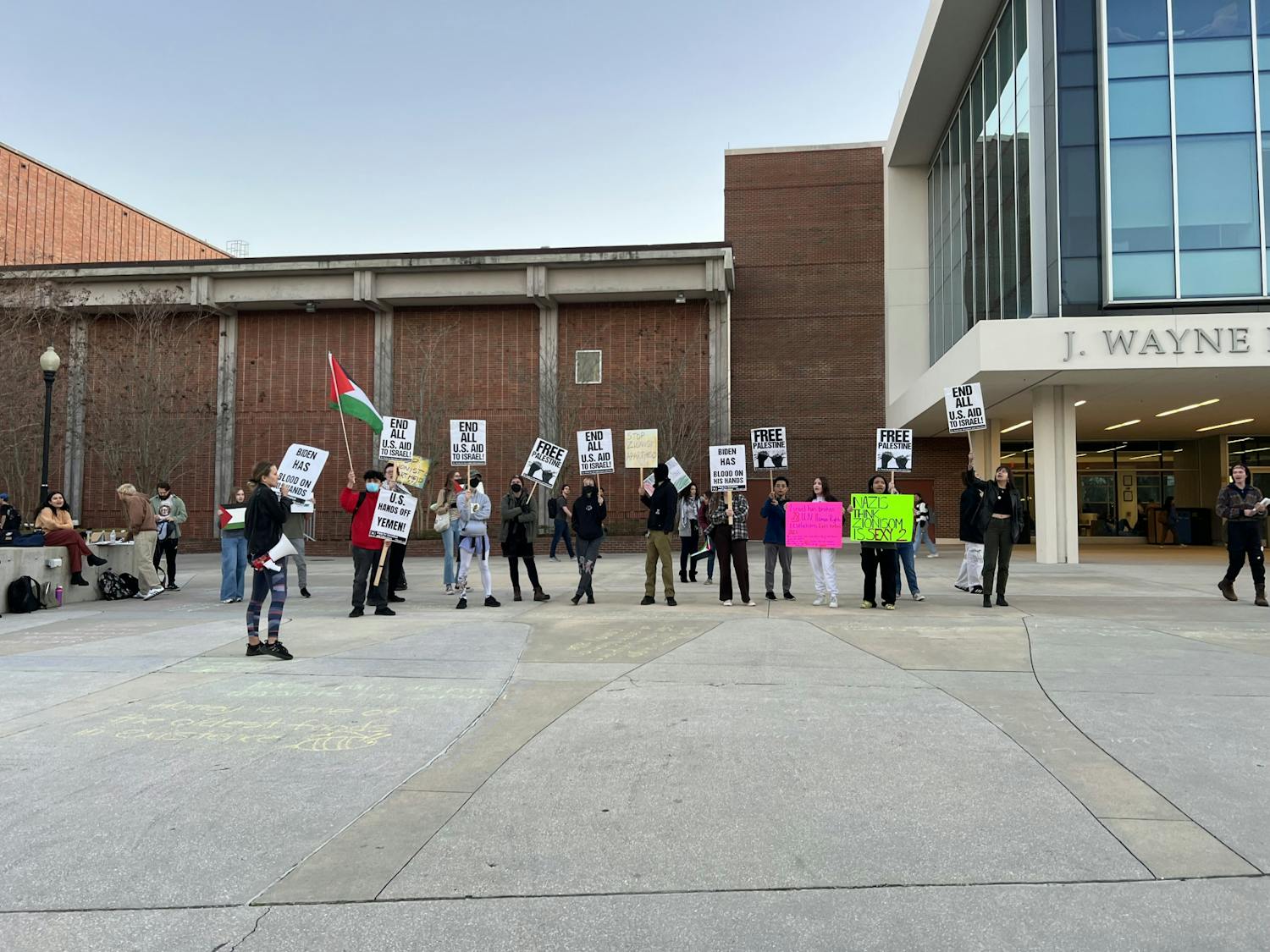 Protesters stand outside the Reitz Union Tuesday, Feb. 6, 2024.