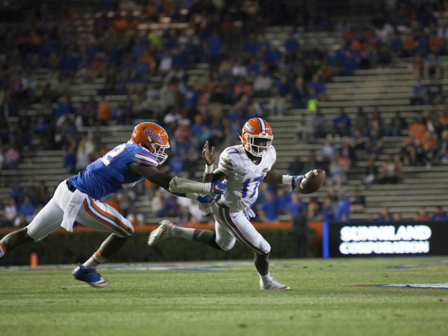 Jordan Smith (left) attempts to tackle Kadarius Toney during Florida’s Orange and Blue Debut on April 7. Smith received four recommended felony charges from the Gainesville Police Department on Wednesday after police said he payed his rent with someone else’s credit card information. Smith had already received 18 recommended felony charges from University Police on Monday after police said he took over $5000 via stolen credit card information, according to UPD reports.