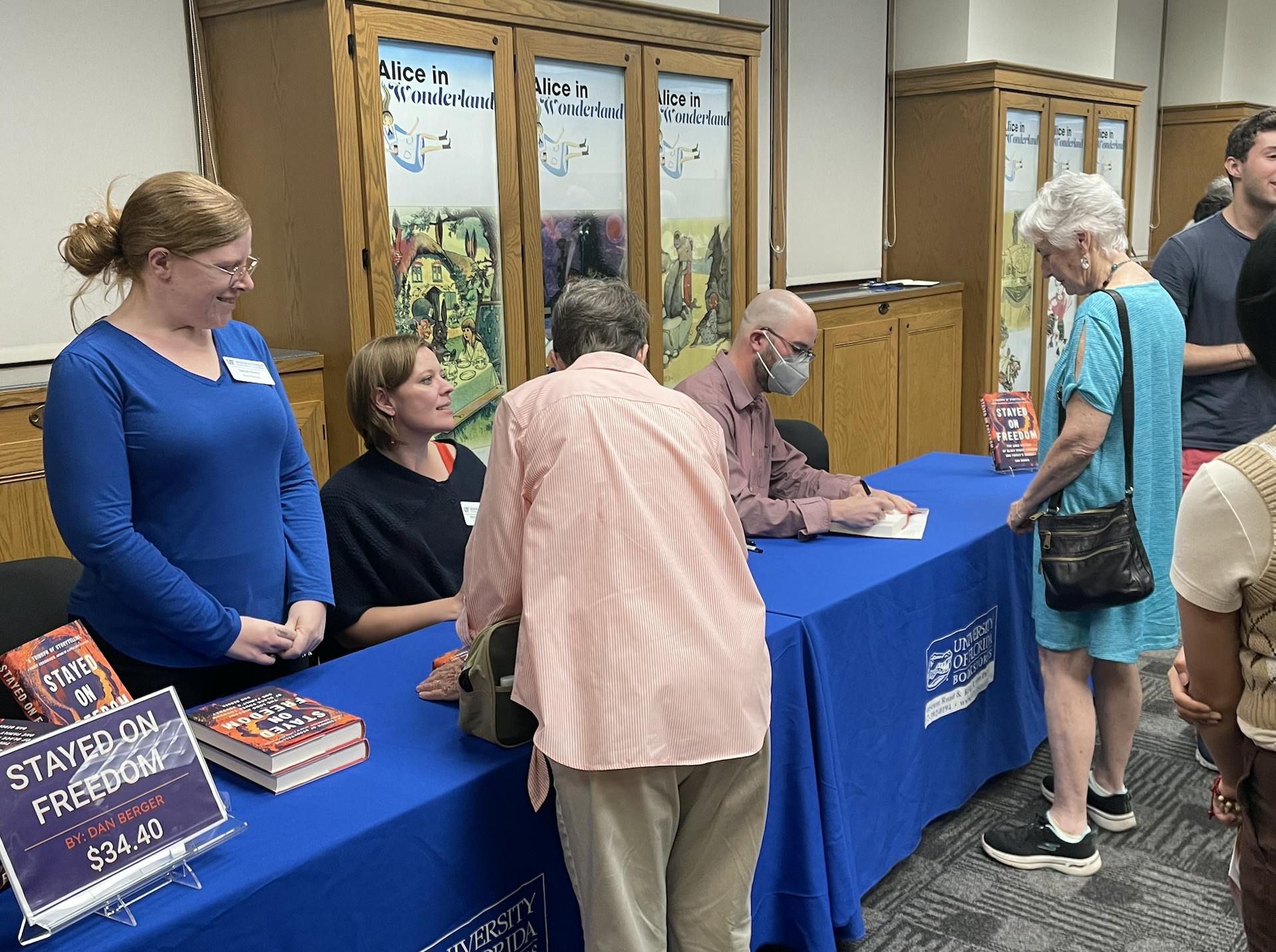 Dr. Dan Berger, a UF alum and author, signs his books and talks with attendees at a UF Samuel Proctor Oral History Program event on Thursday, Feb. 23, 2023.
