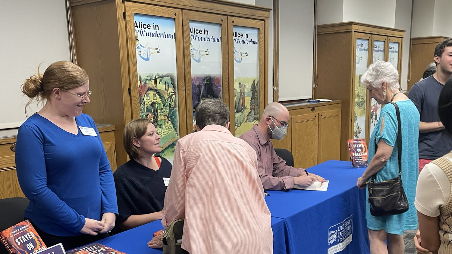 Dr. Dan Berger, a UF alum and author, signs his books and talks with attendees at a UF Samuel Proctor Oral History Program event on Thursday, Feb. 23, 2023.