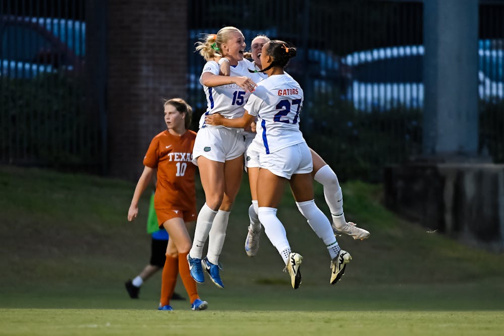 Florida Gators midfielder Lauren Donovan (15) celebrates her first career goal with Florida Gators midfielder Norah Abbott (27) and Florida Gators defender Josie Curtis (9) during the first half at Donald R. Dizney Stadium on Friday, October 04, 2024.