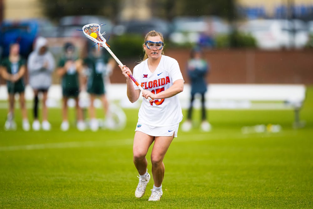 Florida Gators midfielder Josie Hahn (15) runs with the ball in a lacrosse game against Loyola Maryland in Gainesville, Fla., on Saturday, March 8, 2025.