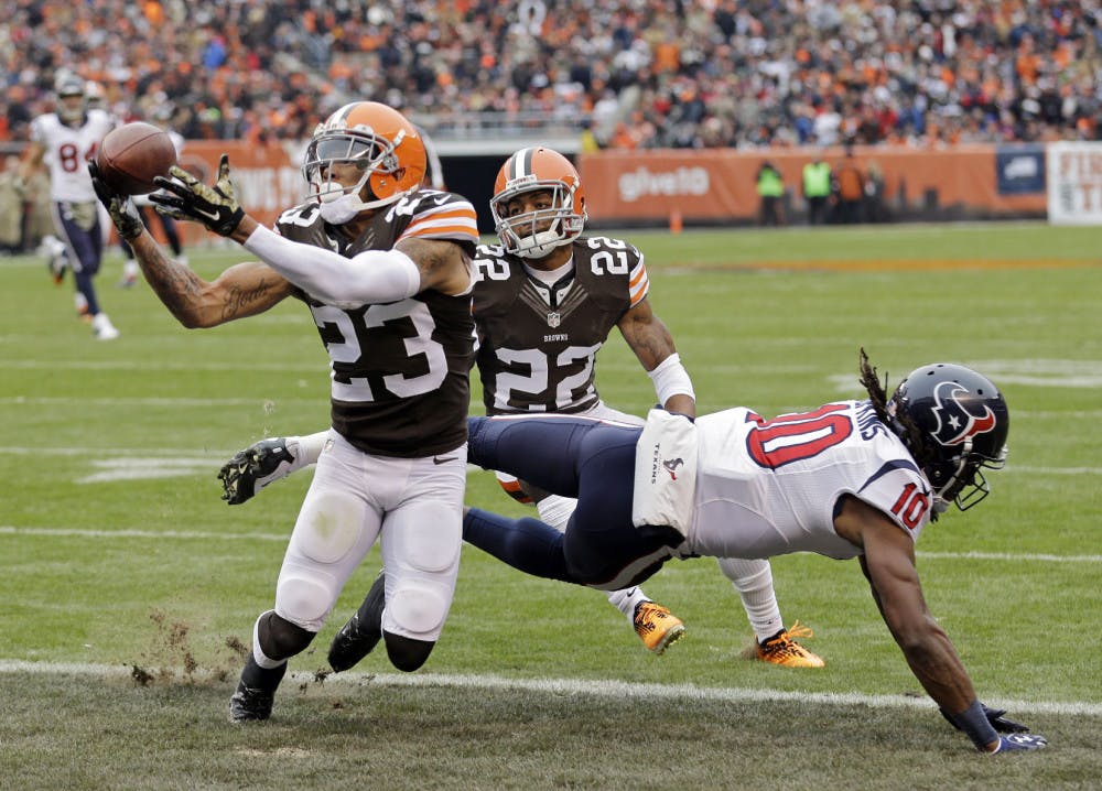 Cleveland Browns cornerback Joe Haden (23) intercepts a pass intended for Houston Texans wide receiver DeAndre Hopkins in the first quarter of an NFL football game Sunday, Nov. 16, 2014, in Cleveland.