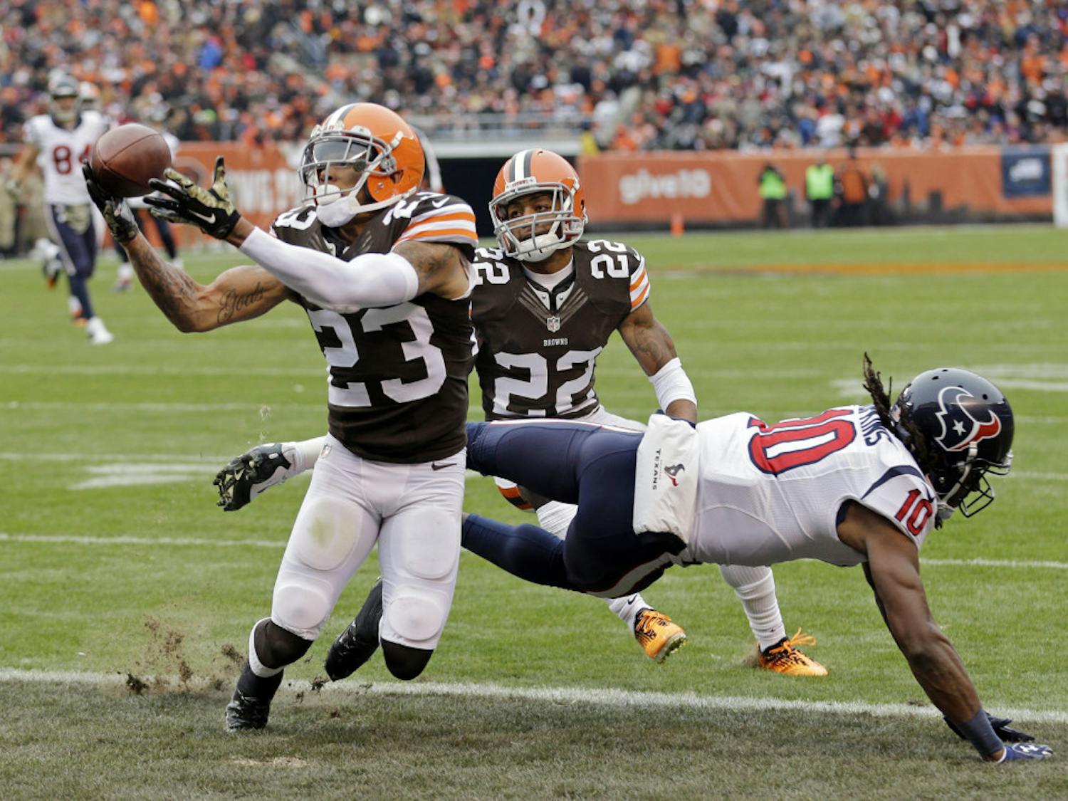 Cleveland Browns cornerback Joe Haden (23) intercepts a pass intended for Houston Texans wide receiver DeAndre Hopkins in the first quarter of an NFL football game Sunday, Nov. 16, 2014, in Cleveland.