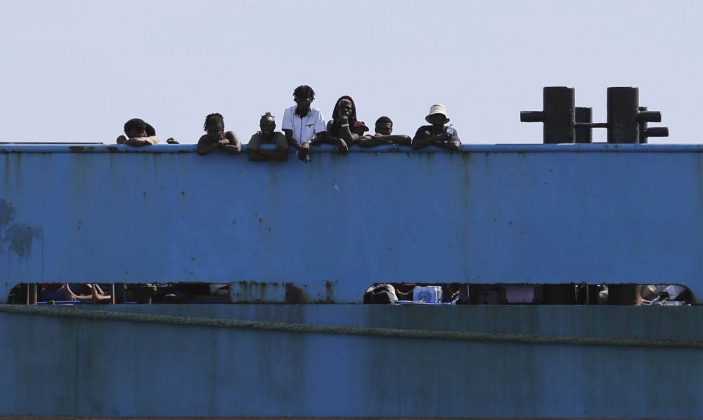 People look out from a ferry as they wait to be evacuated to Nassau in the aftermath of Hurricane Dorian, from the port of Marsh Harbor, Abaco Island, Bahamas, Sunday, Sept. 8, 2019. It's been nearly a week after Dorian roared in from the sea as the most powerful hurricane in the northwestern Bahamas' recorded history.(AP Photo/Fernando Llano)