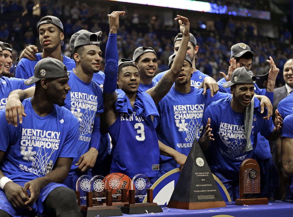 Kentucky's Tyler Ulis (3) celebrates with teammates after an NCAA college basketball game against Texas A&amp;M in the championship of the Southeastern Conference tournament in Nashville, Tenn., Sunday, March 13, 2016. Kentucky won 82-77 in overtime. (AP Photo/Mark Humphrey)