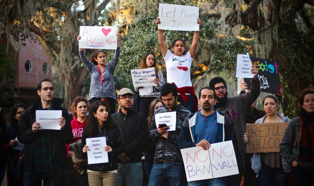 Behnaz, a 42-year-old UF science management masters student who wanted her last name to remain anonymous, stands with a group of more than 120 people on Turlington Plaza to protest President Donald Trump's muslim ban. "This is not together, this is segregation,” she said.