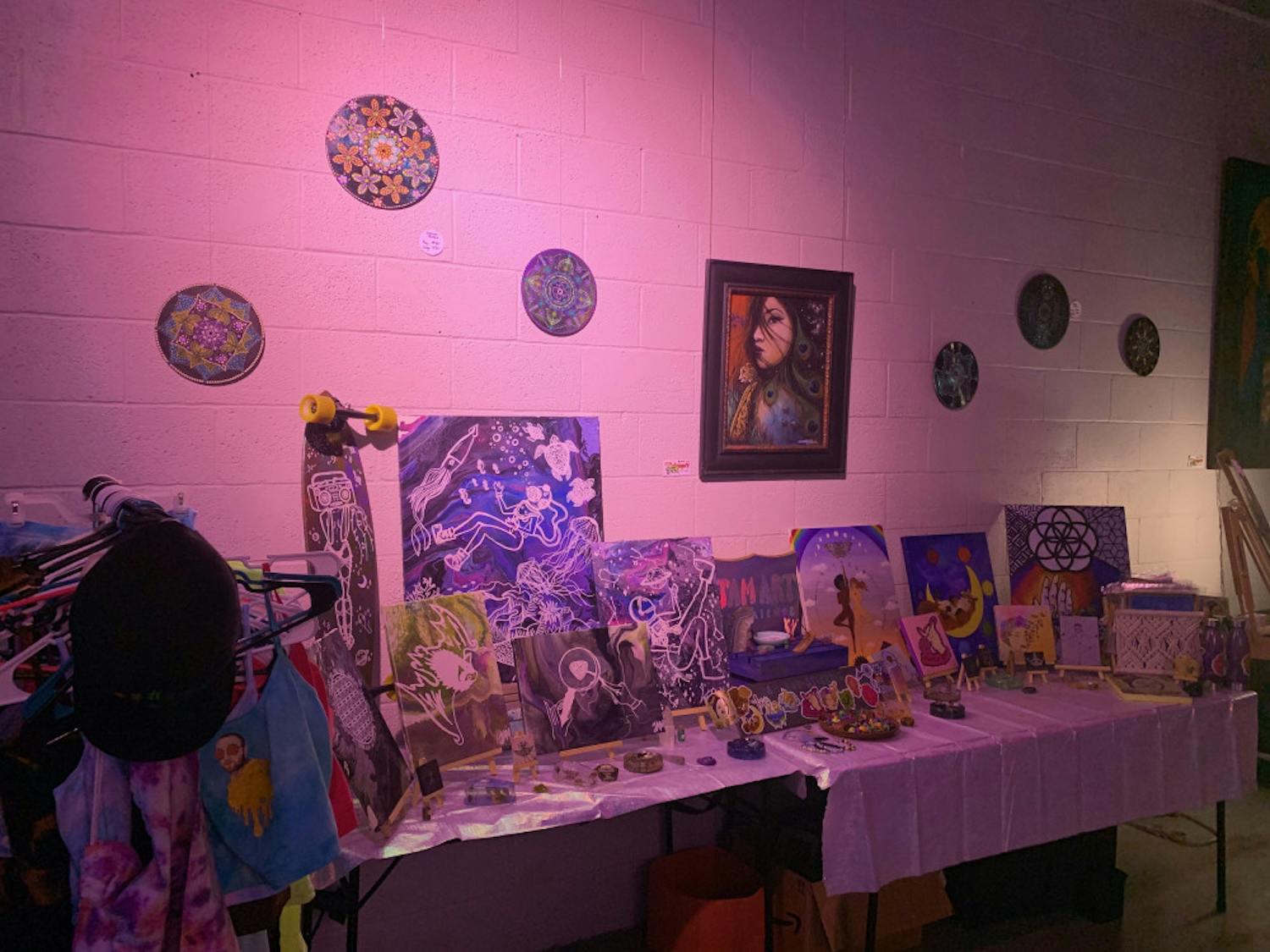 With rainbows and flashing colors of the projector on her art, Julia Monteiro showed her art at the Goddess Visions Artwalk Exhibition. 