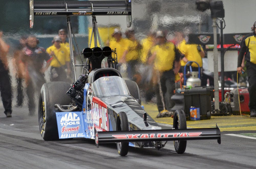 <p>Top Fuel series drag racer J.R. Todd drives down the quarter-mile track at Gainesville's Auto Plus Raceway during a qualifying round at the 2015 Gatornationals on March 14, 2015.</p>