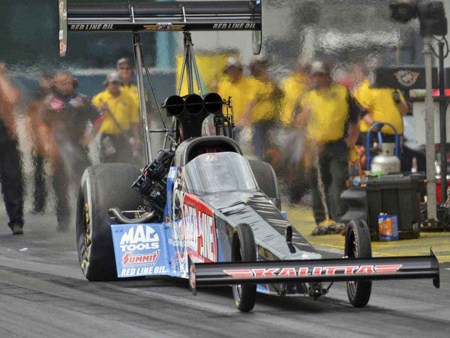 Top Fuel series drag racer J.R. Todd drives down the quarter-mile track at Gainesville's Auto Plus Raceway during a qualifying round at the 2015 Gatornationals on March 14, 2015.