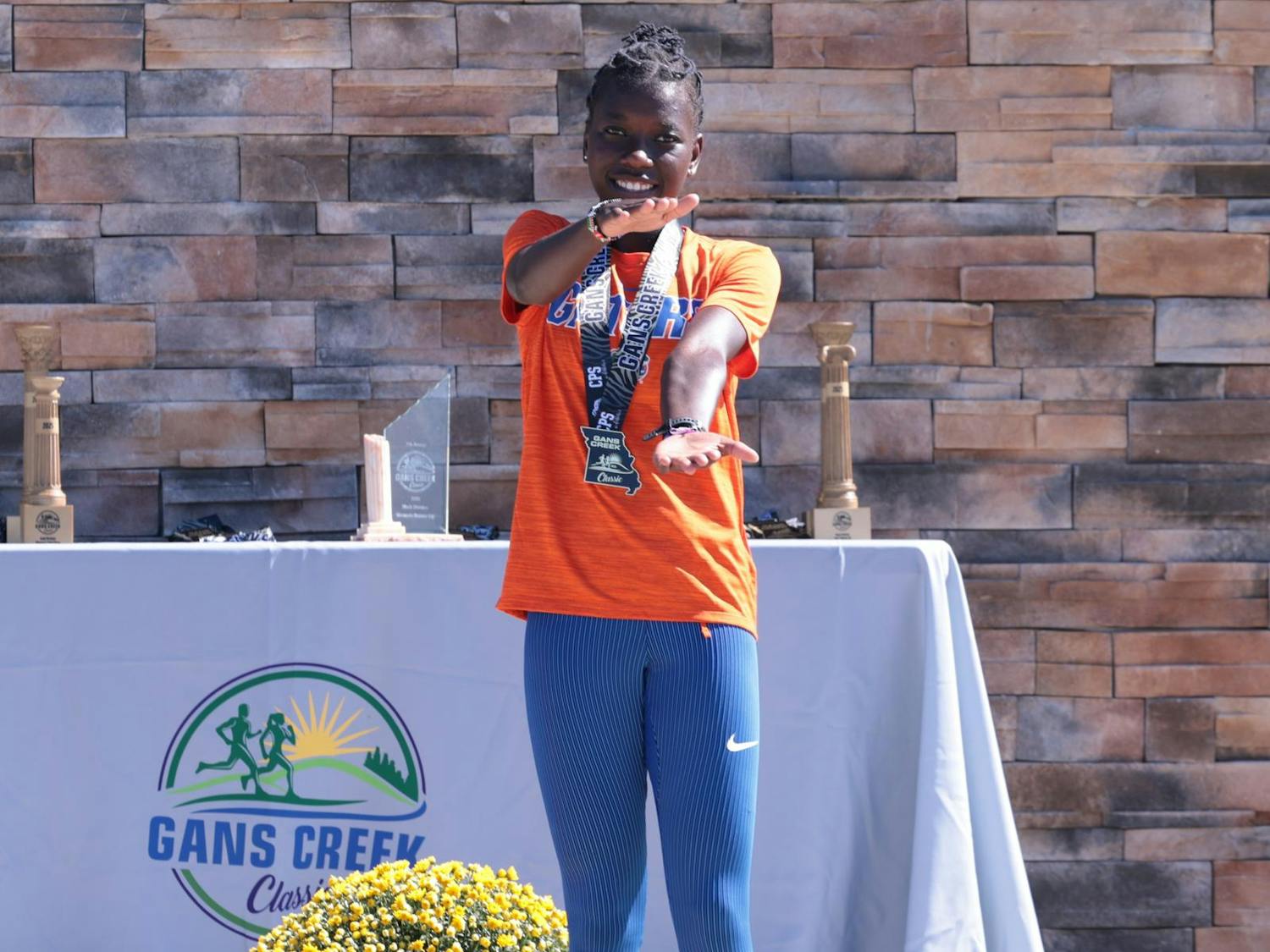 Judy Chepkoech stands on a podium after finishing seventh at the Gans Creek Classic on Friday, Sept. 26, in Columbia, Missouri. (Courtesy UAA Communications)