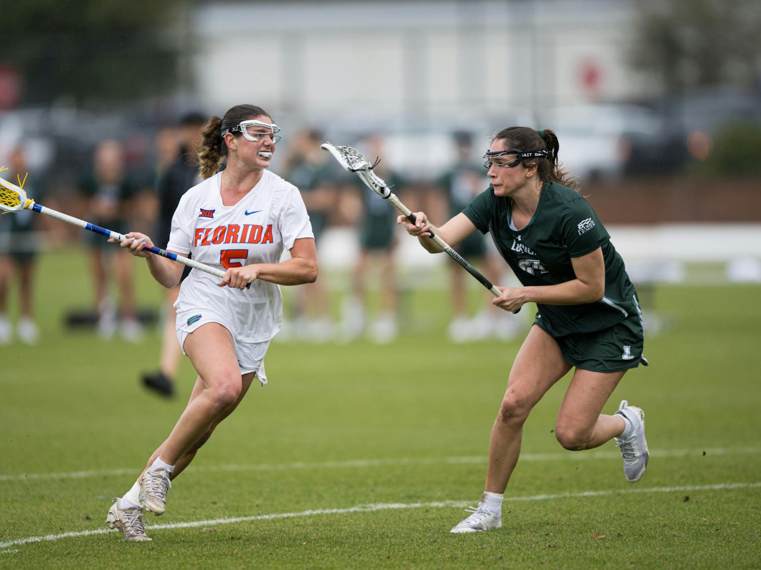 Florida Gators midfielder Kaitlyn Davies (5) runs with the ball in a lacrosse game against Loyola Maryland in Gainesville, Fla., on Saturday, March 8, 2025.