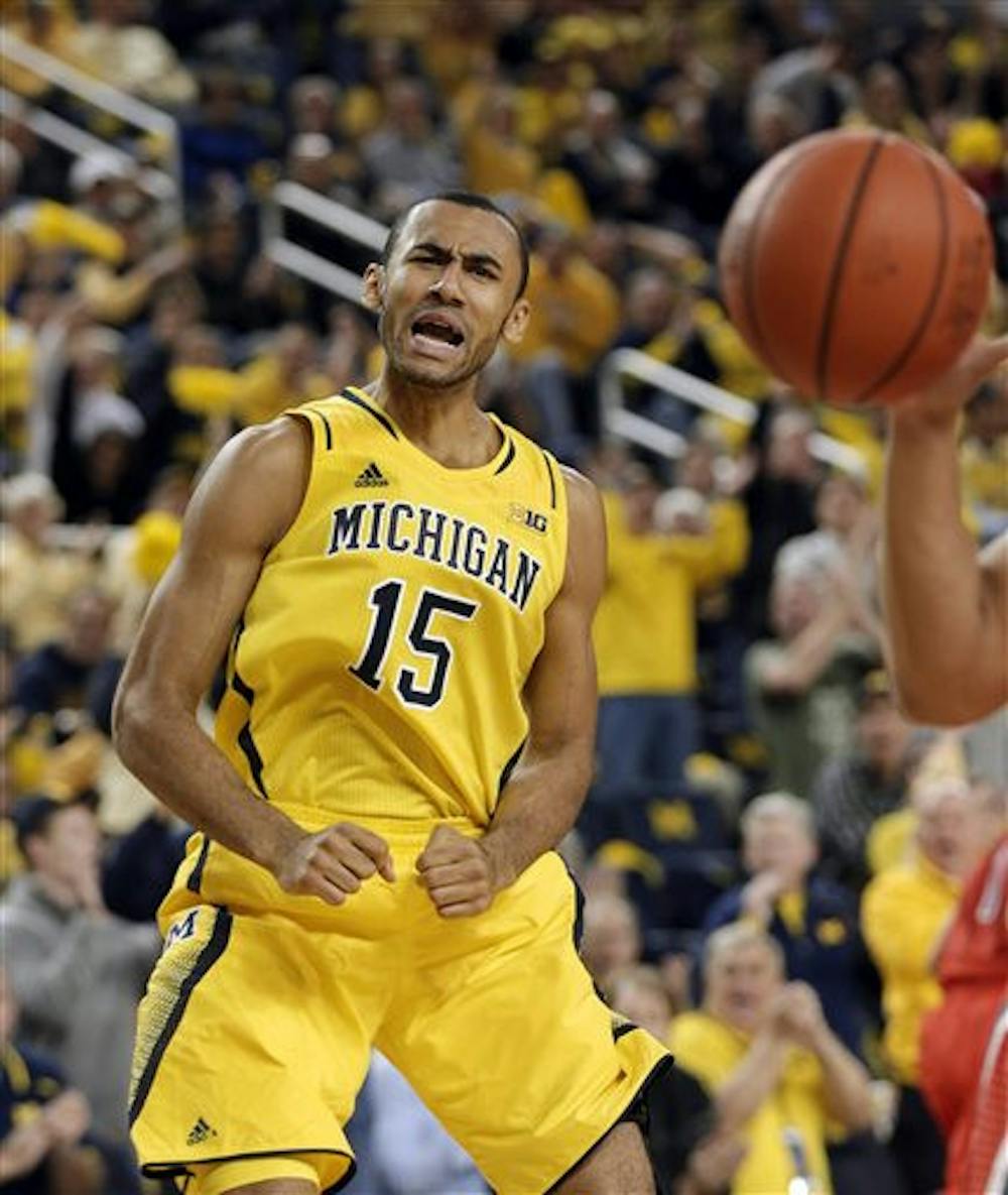 <p>Michigan forward Jon Horford reacts after making a basket during a game against Arizona in Ann Arbor, Mich., on Dec. 14.</p>