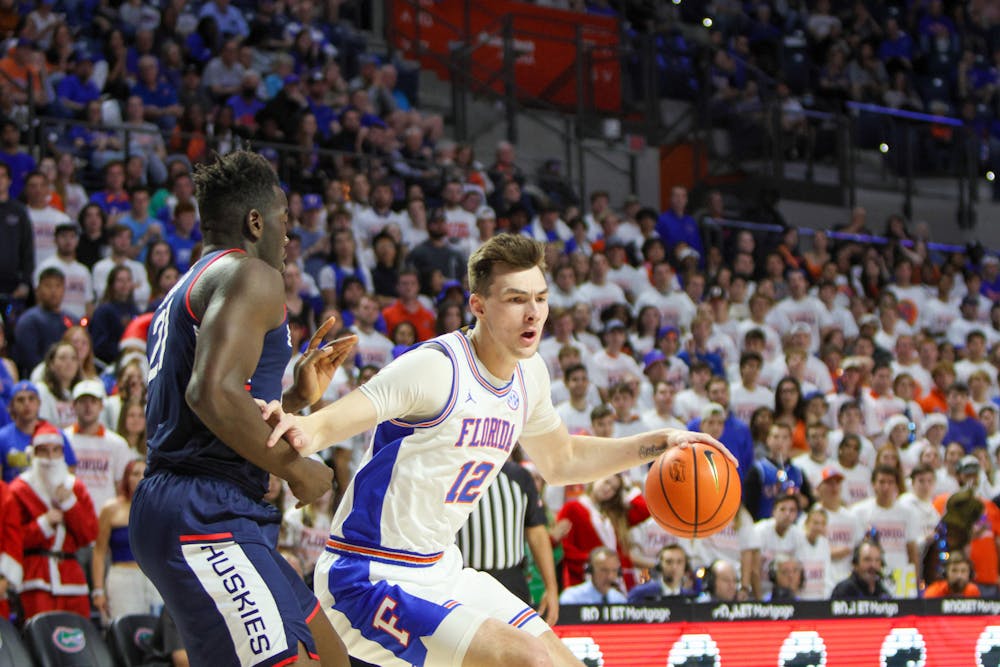 <p>Fifth-year forward Colin Castleton drives past UConn forward Adama Sanogo during Florida&#x27;s loss to the No. 5 Huskies Wednesday, Dec. 7, 2022. </p>
