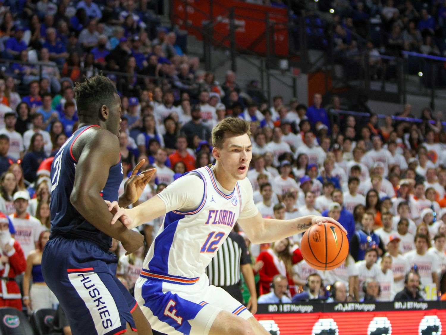 Fifth-year forward Colin Castleton drives past UConn forward Adama Sanogo during Florida&#x27;s loss to the No. 5 Huskies Wednesday, Dec. 7, 2022. 