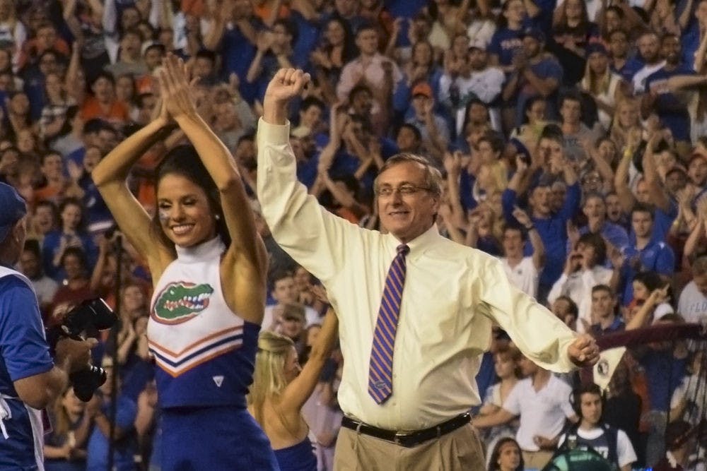 <p>UF President Kent Fuchs leads a crowd of more than 90,000 people in a cheer as honorary Mr. Two Bits before the Florida State University game on Nov. 28, 2015, in Ben Hill Griffin Stadium. “It was incredible,” he said afterwards, about leading the cheer.</p>