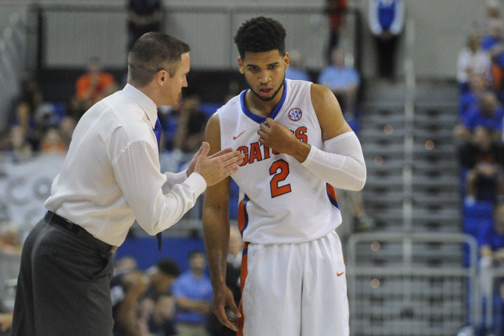 <p>UF men's basketball coach Mike White talks with redshirt freshman guard Brandone Francis-Ramirez during the first half of Florida's 89-42 win against Palm Beach Atlantic in an exhibition game Nov. 5, 2015, in the O'Connell Center.</p>